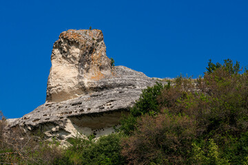 Ancient cave city, Baqla, View from the outside. Rock in the form of the head of a snake Cobra....