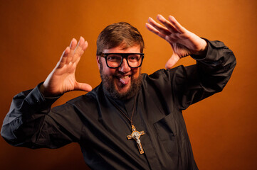Portrait of a priest with crucifix showing the palm of his hands.