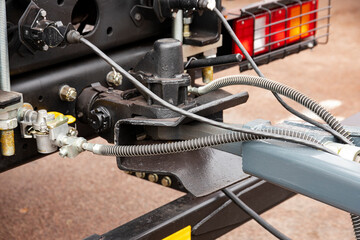 Car coupler for attaching a trailer and semi-trailer to a truck.