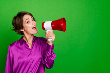 Portrait of bob brown hair worker lady protest against employers who decrease salaries holding megaphone isolated on green color background