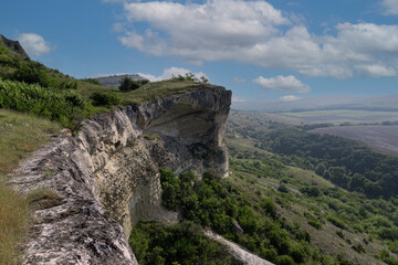 Fototapeta na wymiar Mountain valley with a sheer cliff, mountain peak, mountain landscape, top view.