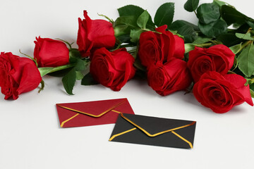 Red roses with envelopes on white background. Valentine's day concept