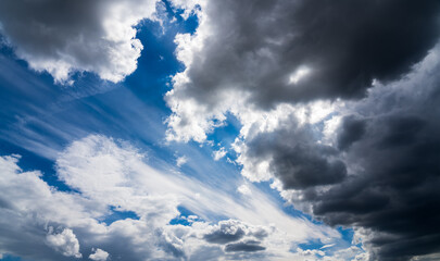 White dramatic cumulus clouds in the blue sky. Cloudy sky background. Overcast weather.
