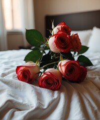Pristine bed setting adorned with a bouquet of fresh, vibrant roses.