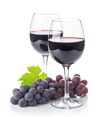 Two glasses of red wine accompanied by a lush cluster of grapes, showcasing the journey from vine to glass.