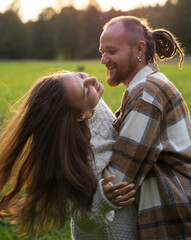 Fototapeta premium man and woman in love kiss and hug outdoors in the park