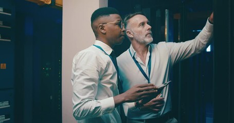 Server room, men and tablet with talking for database, information technology and pointing to data. Datacenter, mentor or employee with instructions to store and power computer hardware on the system