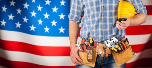 Professional male labour with tools equipment at USA flag background