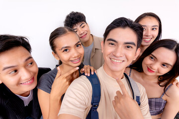 A cheerful group of six young friends smiling and posing for a selfie, capturing a joyous moment...