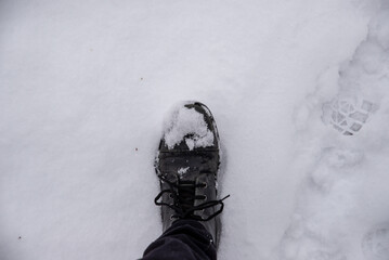 leather boots in the snow, top view