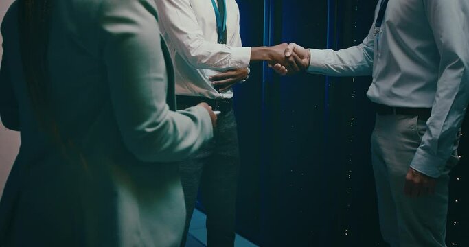 People, shaking hands and server room success, onboarding or cyber security agreement or programming. Business technician handshake for congratulations, deal or thank you in data center or promotion