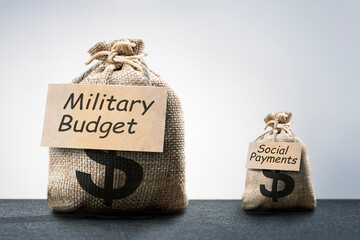 high of spending on weapons comparison small social expenses. budget deficit of social expenses. military budget growth up. - obrazy, fototapety, plakaty