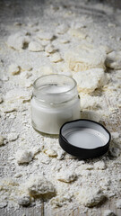 Coconut oil in jars on a coconut background