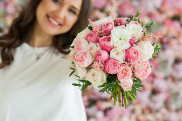 Pink and white rose flower bouquet in female hand, love, birthday and holiday concept