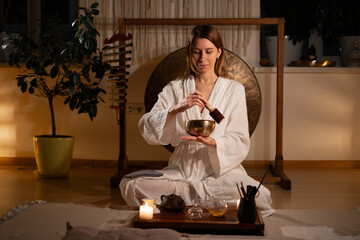 Traditional chinese ceremony. Woman performs the sacrament of an oriental tea ceremony at home for...
