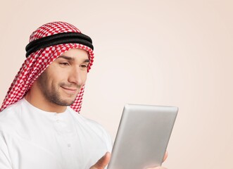 A Saudi arab character man holding a digital tablet