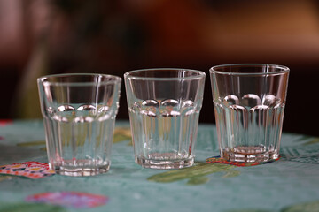 Three glasses of water on the kitchen table.