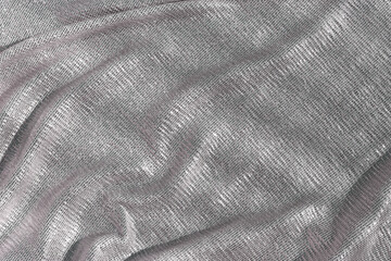 Top view image of aesthetic background. silver silk satin cloth with texture