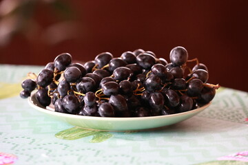 Fresh black grapes on the kitchen table.
