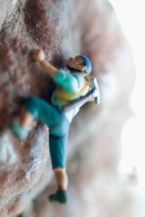 miniature figurine of a climber on a mountain