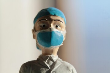 miniature figure portrait of a surgeon with a medical mask