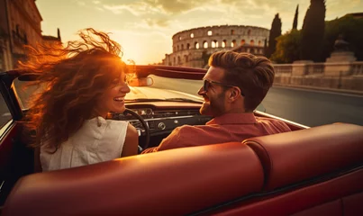 Selbstklebende Fototapeten Happy smiling couple, man and woman, traveling in a convertible Rome Italy on a summer sunny day. © Andrii IURLOV