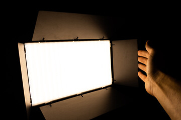 Professional photo or video lighting. SRGB Led-panel on tripod for home or studio shooting. Adjusting light equipment.