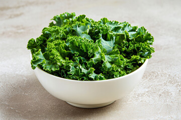 a bowl of kale above wooden table