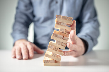 Planning, insurance, risk and strategy in business, man holding up falling tower