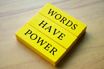 Top view of yellow wooden blocks with text Words Have Power. Motivational and inspirational concept