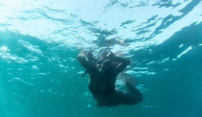 Funny brunette woman snorkeling.Underwater