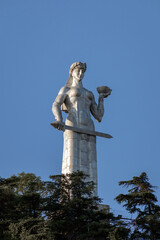 Mother Kartli  - Symbols of the city Tbilisi. The statue holds a cup of wine in one hand for friends and a sword in the other for enemies. Early morning. Summer day.
