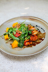 Delicious Seafood salad with vegetables and shrimps on the table