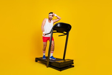 Full length photo of sporty tired person walk treadmill sweating cardio empty space isolated on...
