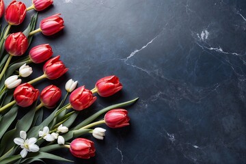 tulips and snowdrops on blue marble with copy space