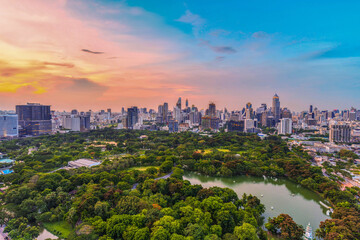 Lumpini park and Bangkok city central business downtown bird eye view landscape at twilight time.