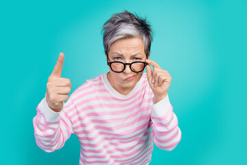 Photo of funny strict lady wear striped sweater hand arm spectacles pointing you isolated turquoise...