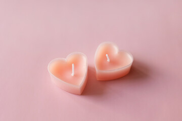 pair of candles tablets in shape of heart. valentine's day. minimal background