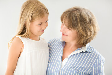 Mature woman embrace with young girl