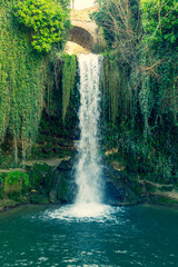 Tobera waterfall in Burgos. Surrounded by green vegetation. Located in Castilla y Leon, Spain