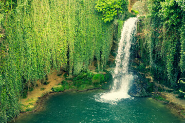 Tobera waterfall in Burgos. Surrounded by green vegetation. Located in Castilla y Leon, Spain