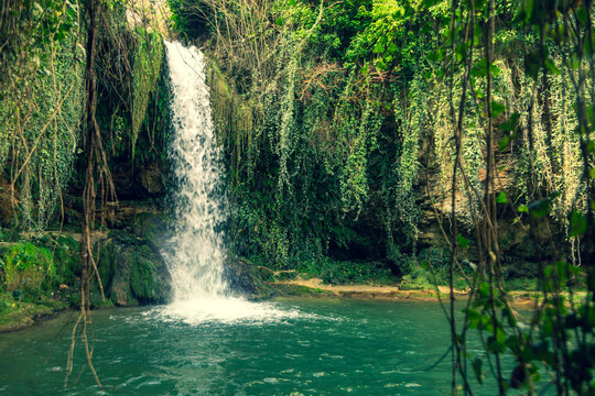 Tobera waterfall in Burgos. Surrounded by green vegetation. Located in Castilla y Leon, Spain