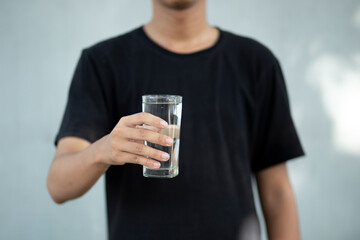 Close up of a man hands holding a water glass