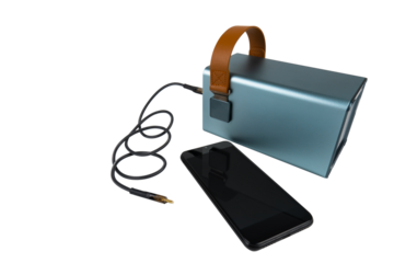 A turned off smartphone lies next to a large power bank (charging station) with a USB cable on a transparent background. Mobile power supply