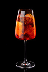 Aperol spritz summer cocktail in glass with bubbles. Black background.For restaurant menu.