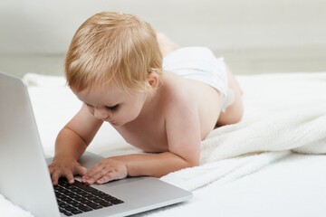 Baby, learning and playing on laptop in home with online games for education or elearning. Happy, child and relax with cartoon, movies or development of knowledge of technology for growth and fun