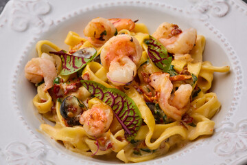 Shrimp fetticcine pasta. Italian pasta with shrimps and cream alfredo sauce, top view, copy space.Closeup