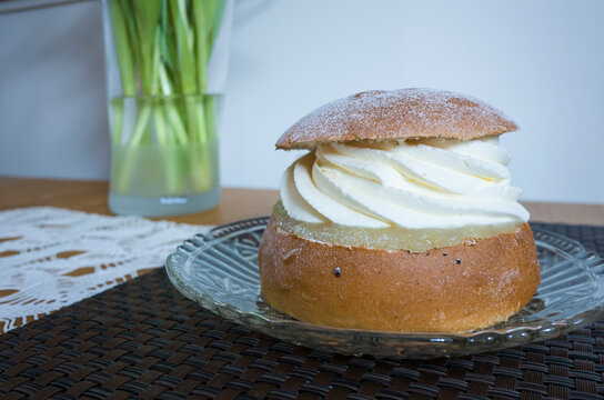 Traditional Swedish semla consists of a cardamom-spiced wheat bun with sweet almond paste and whipped cream filling