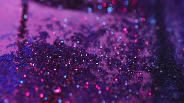 Wet glitter texture. Paint flow. Defocused neon blue pink purple color shimmering bokeh light circles acrylic ink water wave motion abstract art background.
