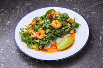 fresh healthy shrimps salad with arugula,dried tomatoes and grapes.